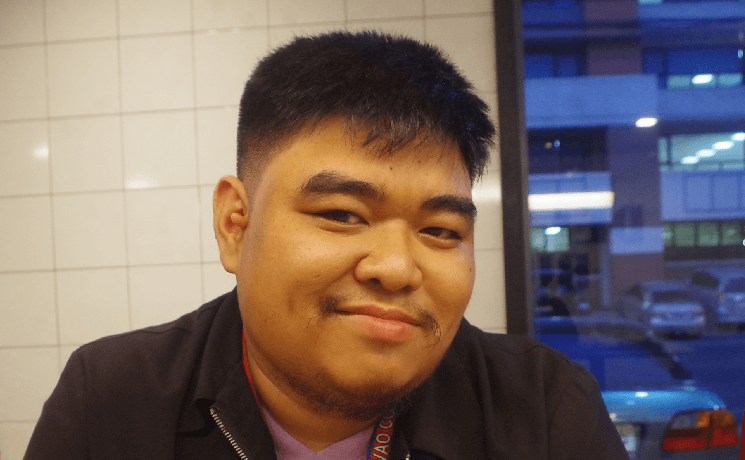 Portrait of John Rey Silverio smiling indoors